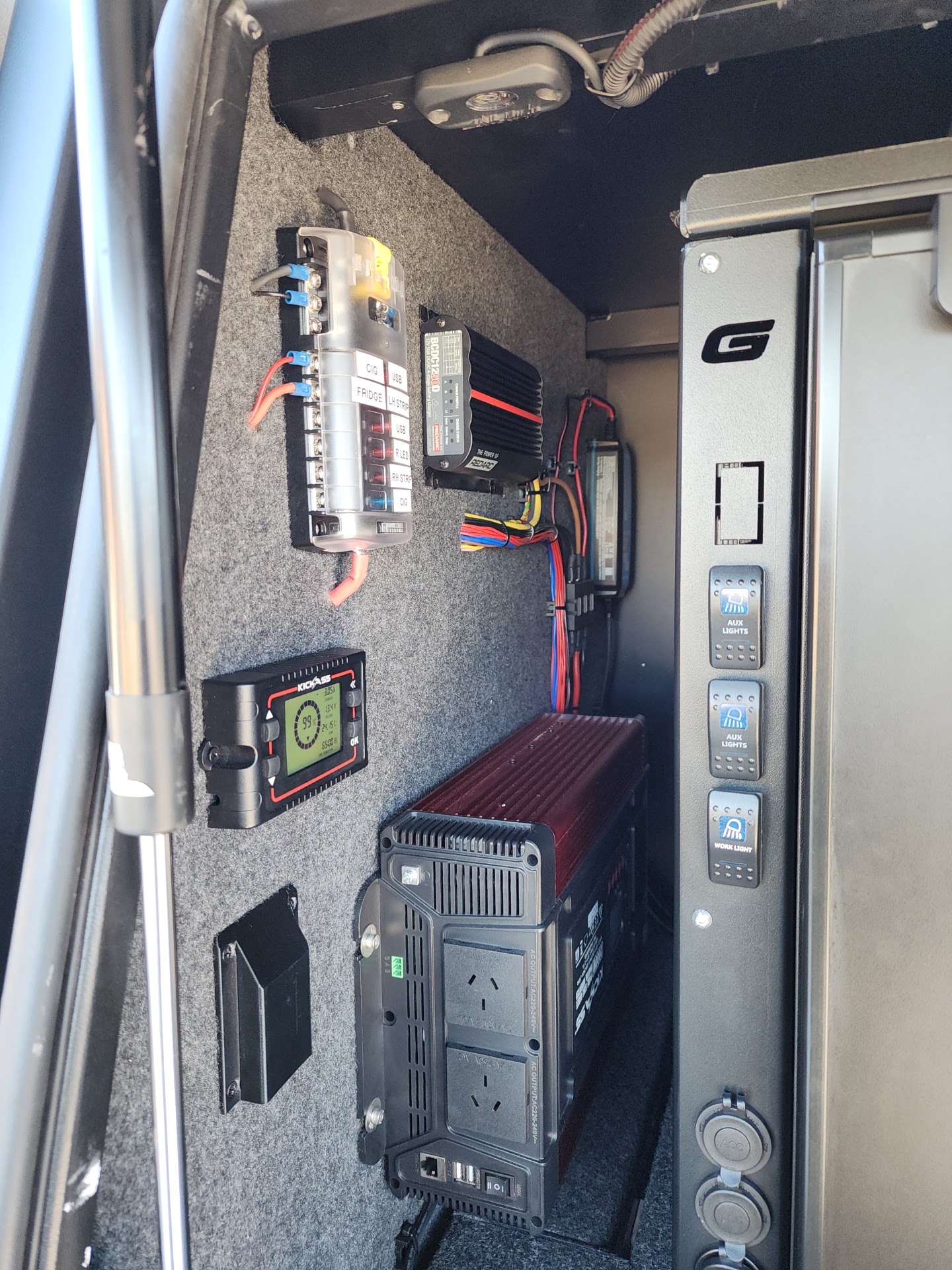 Canopy side panel with a fuse block, Redarc DC-DC charger, KickAss battery monitor and an inverter with power outlets