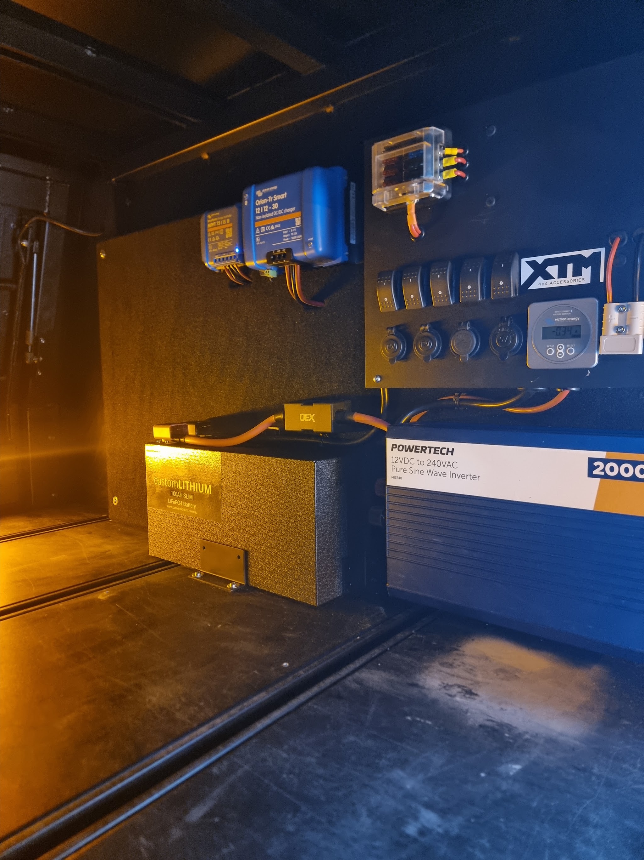 Inside a canopy: lithium battery, 2000W pure sine inverter, DC-DC chargers and a switch panel with sockets
